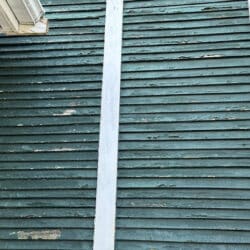 Peeling green paint on wall