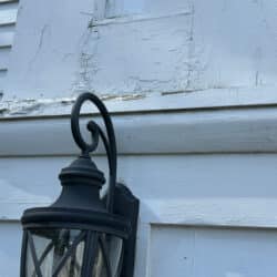 Corner with peeling paint and light fixture