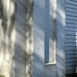 Arched window with peeling paint details